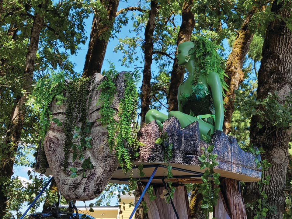 This kinetic sculpture by Marilyn Kurka represents a tree that got burnt down in a forest fire, but rises from the ashes with new seedlings and a tree fairy on top to help protect Mother Earth.